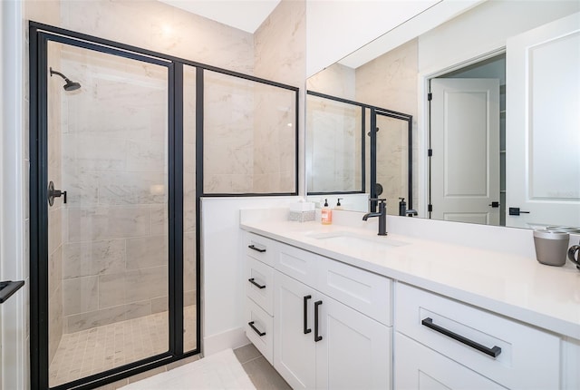 bathroom with a shower with shower door, tile patterned flooring, and vanity