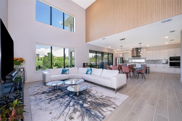 living room with a high ceiling and sink