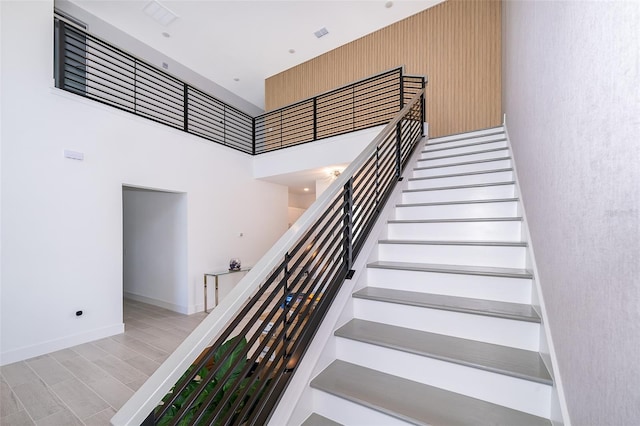 stairs featuring a high ceiling