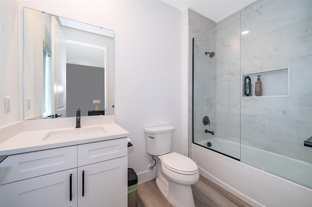 full bathroom featuring vanity, toilet, tiled shower / bath combo, and wood-type flooring