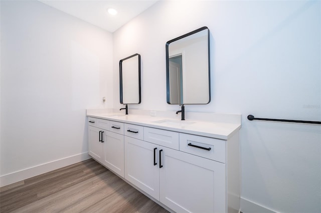 bathroom with vanity and wood-type flooring