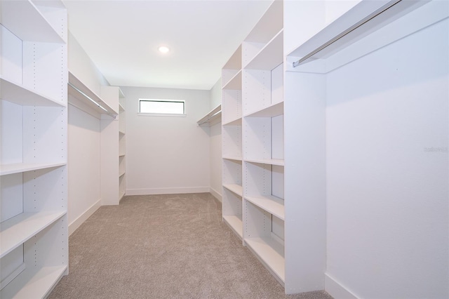 walk in closet featuring light carpet