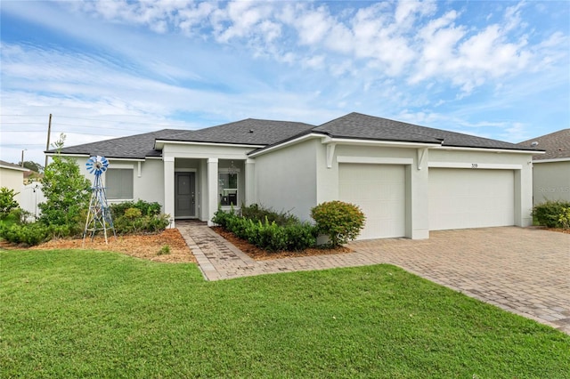 view of front facade featuring a garage and a front lawn