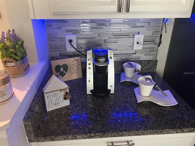 details featuring white cabinets and decorative backsplash