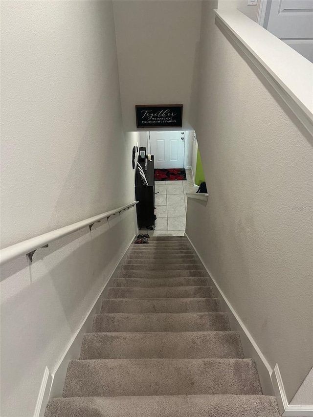 stairway with tile patterned flooring