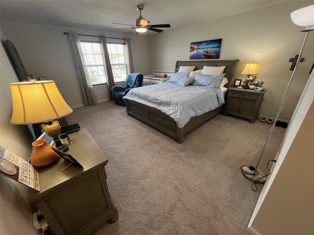 bedroom featuring ceiling fan and light carpet