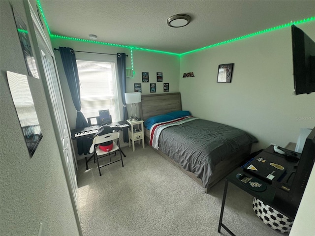 bedroom featuring carpet flooring and a textured ceiling