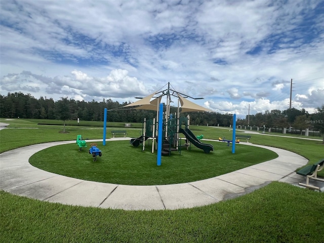 view of playground with a lawn