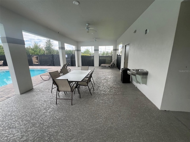 view of patio featuring a fenced in pool and ceiling fan