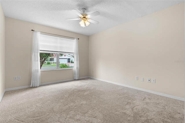 carpeted spare room with a textured ceiling and ceiling fan