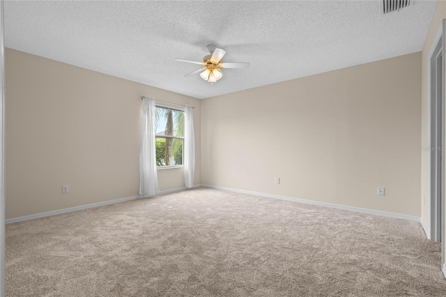 carpeted spare room with ceiling fan and a textured ceiling