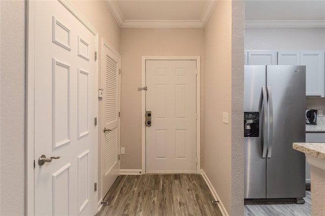 entryway with crown molding and hardwood / wood-style flooring