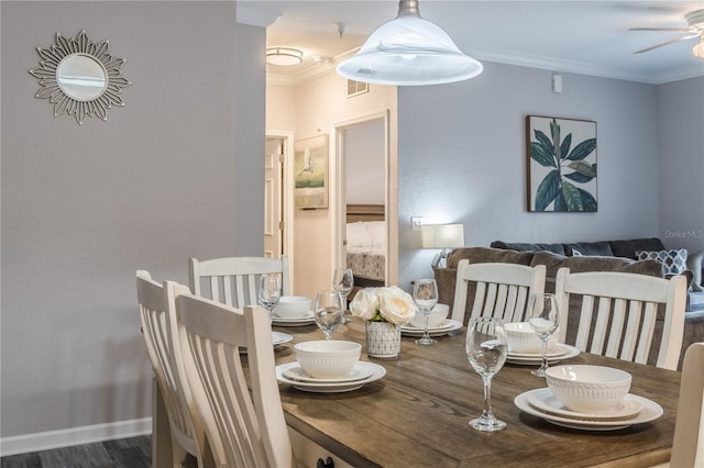 dining area featuring ceiling fan, crown molding, and dark wood-type flooring