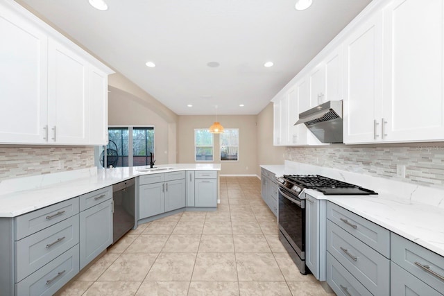 kitchen with stainless steel appliances, white cabinetry, sink, and decorative light fixtures