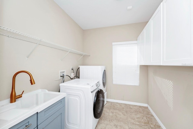 clothes washing area with cabinets, separate washer and dryer, sink, and light tile patterned floors