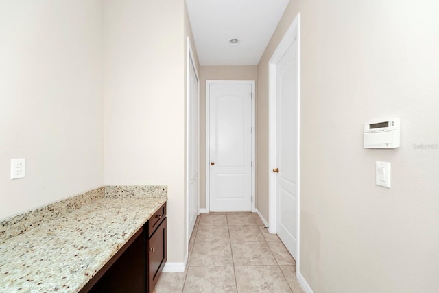 hall featuring light tile patterned flooring