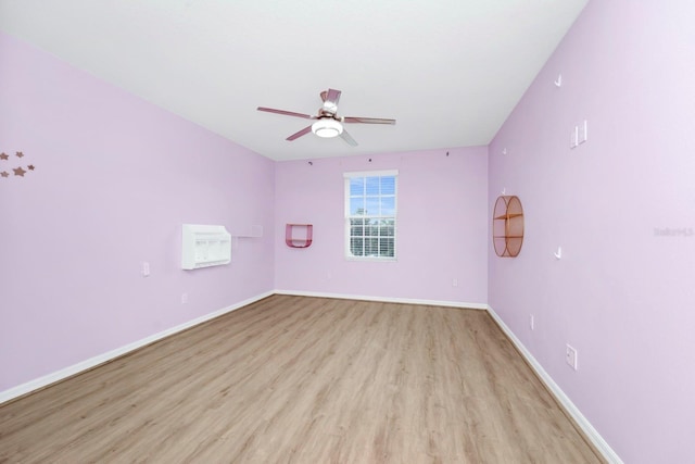 empty room with ceiling fan and light wood-type flooring