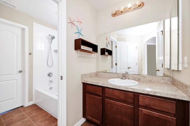 bathroom with tiled shower / bath combo, vanity, and tile patterned floors