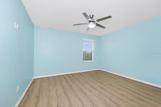 unfurnished room with ceiling fan and light wood-type flooring