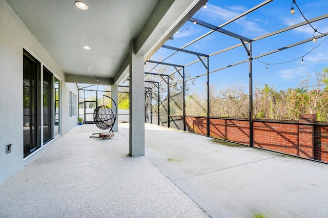 view of patio / terrace featuring a lanai