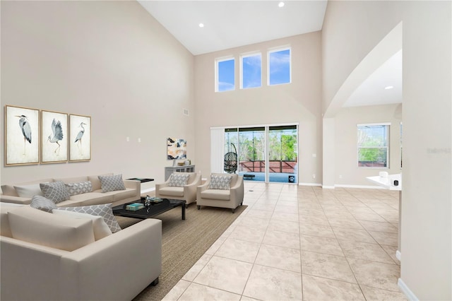 living room featuring light tile patterned flooring and a high ceiling