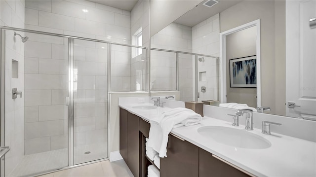 bathroom with vanity, tile patterned flooring, and an enclosed shower