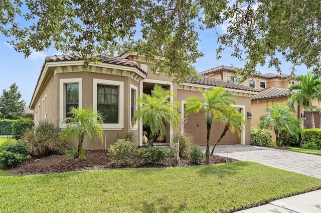 mediterranean / spanish-style home with a front lawn and a garage