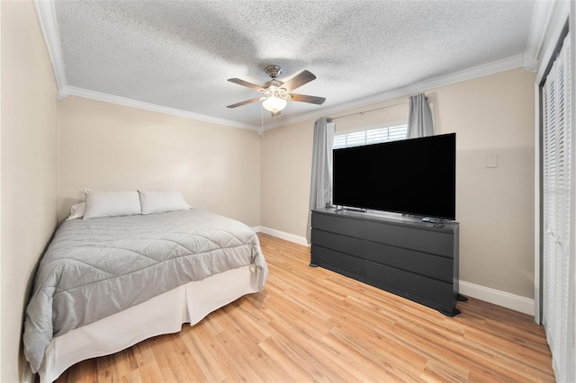 bedroom featuring ornamental molding, a textured ceiling, hardwood / wood-style flooring, and ceiling fan