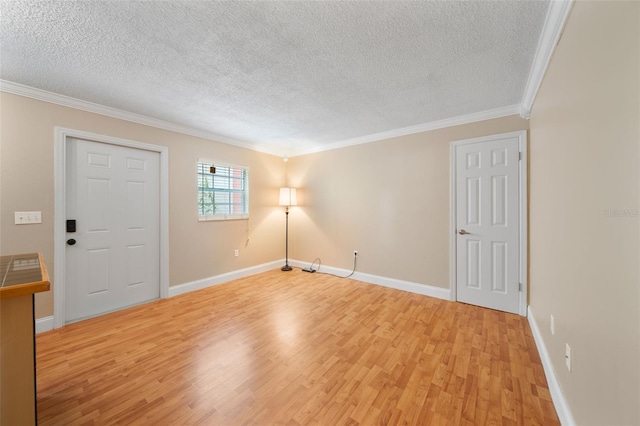 interior space featuring ornamental molding, a textured ceiling, and light hardwood / wood-style flooring