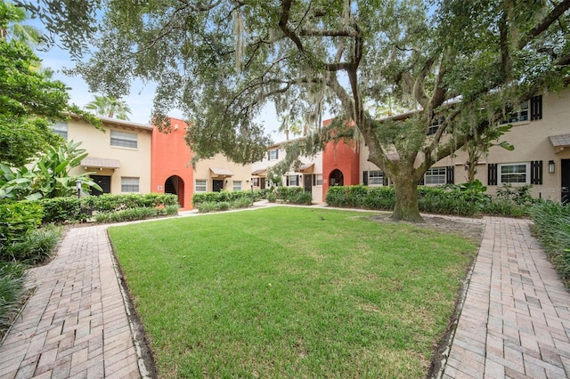 view of home's community with a yard