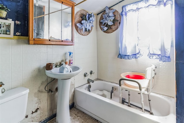 bathroom featuring tile walls and toilet