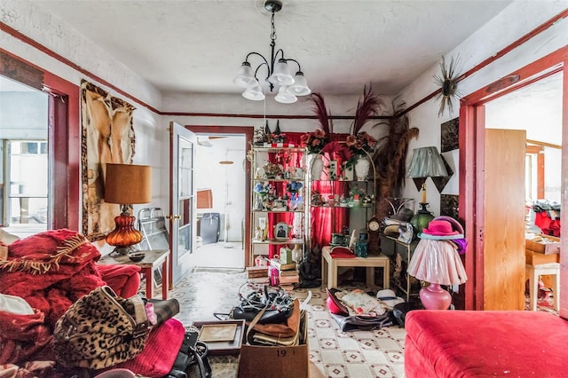 miscellaneous room featuring a healthy amount of sunlight and a notable chandelier