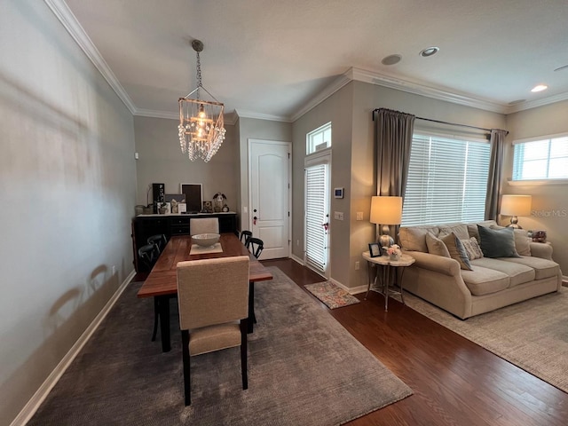 dining area with crown molding, dark hardwood / wood-style floors, and a chandelier