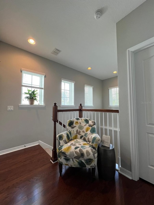 sitting room with dark wood-type flooring