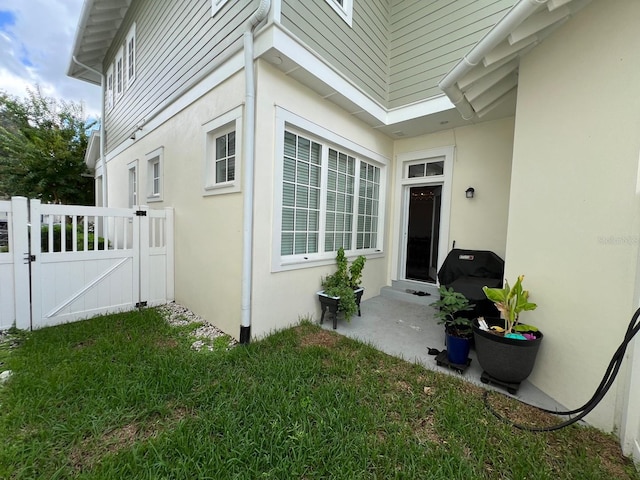 view of side of home with a lawn