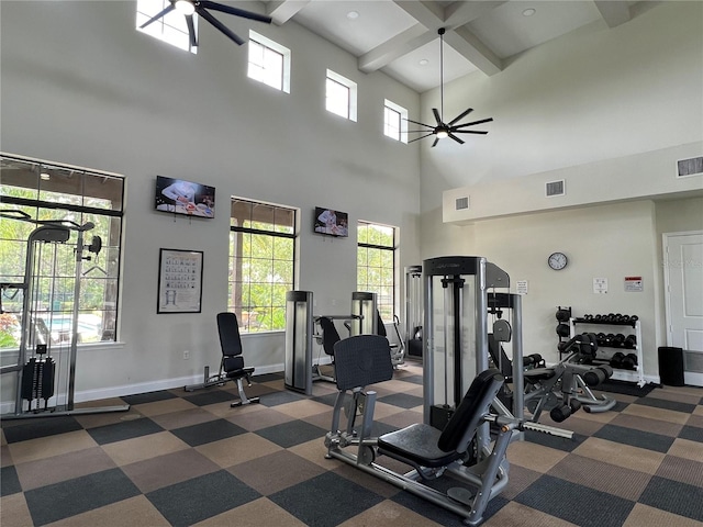 workout area featuring a towering ceiling and ceiling fan