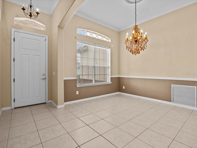 entrance foyer featuring baseboards, crown molding, visible vents, and a notable chandelier