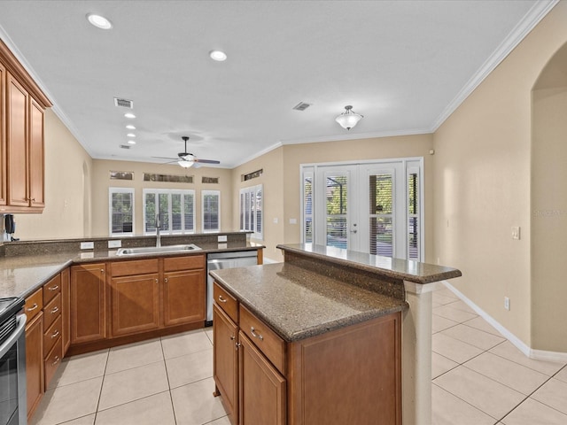 kitchen featuring a kitchen island, brown cabinets, a sink, french doors, and stainless steel dishwasher