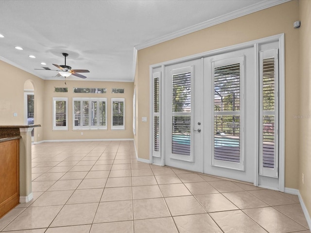 interior space with light tile patterned floors, baseboards, a ceiling fan, crown molding, and french doors