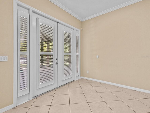 doorway to outside featuring light tile patterned floors, baseboards, ornamental molding, and french doors