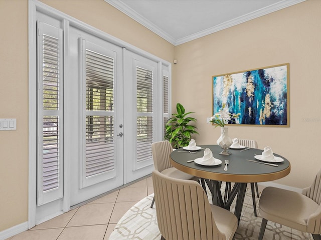 dining room with french doors, light tile patterned flooring, crown molding, and baseboards