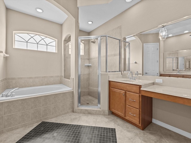 full bathroom featuring a stall shower, vanity, a bath, and tile patterned floors