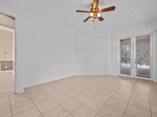 spare room with french doors, ceiling fan, and light tile patterned floors