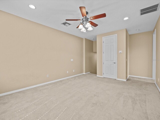 unfurnished bedroom featuring baseboards, visible vents, light colored carpet, and recessed lighting