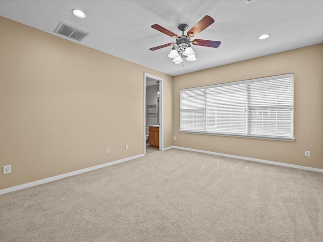 unfurnished room with ceiling fan, recessed lighting, light colored carpet, visible vents, and baseboards