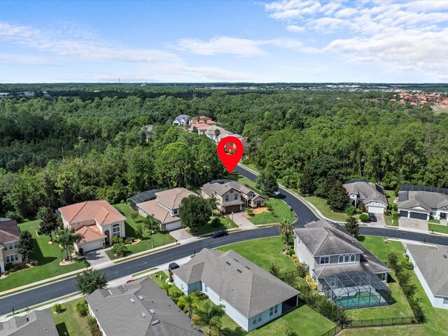 birds eye view of property with a residential view and a view of trees