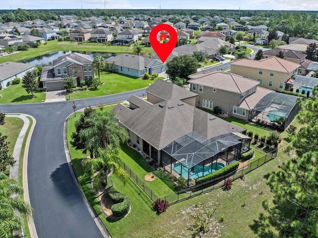 birds eye view of property featuring a water view and a residential view