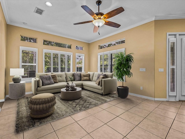 living room with light tile patterned floors, ornamental molding, a ceiling fan, and baseboards