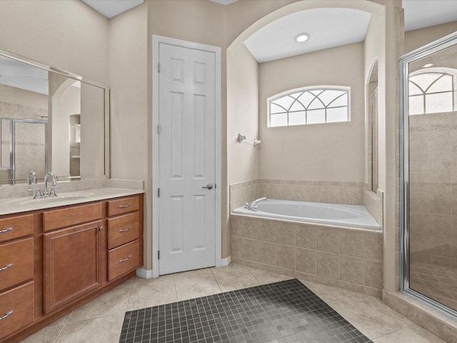 full bath with plenty of natural light, tile patterned flooring, a bath, and a shower stall