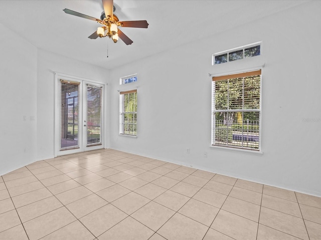 empty room with french doors and ceiling fan